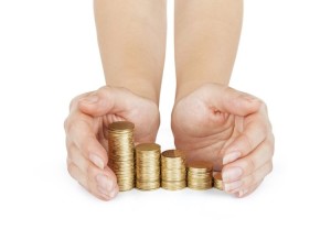 Savings protection, close up of female hands covering stack of g